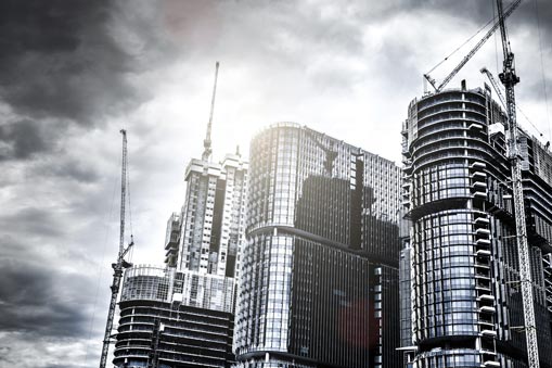 Commercial buildings with cranes in the background